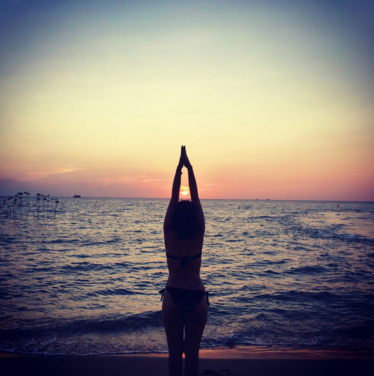 silhouette photography of woman raising her hands