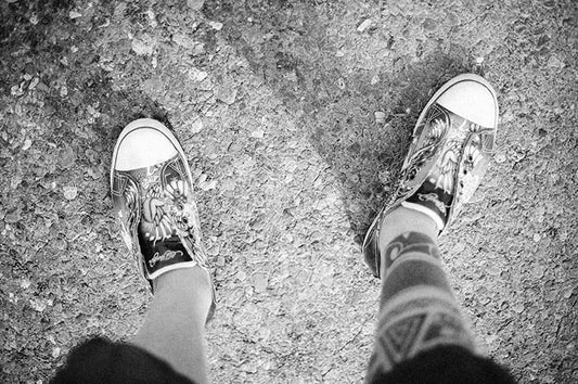 a pair of feet standing next to each other