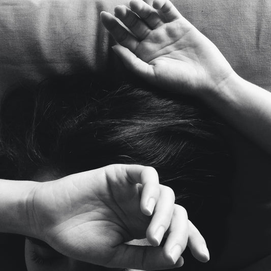 a woman covering her head with her hands