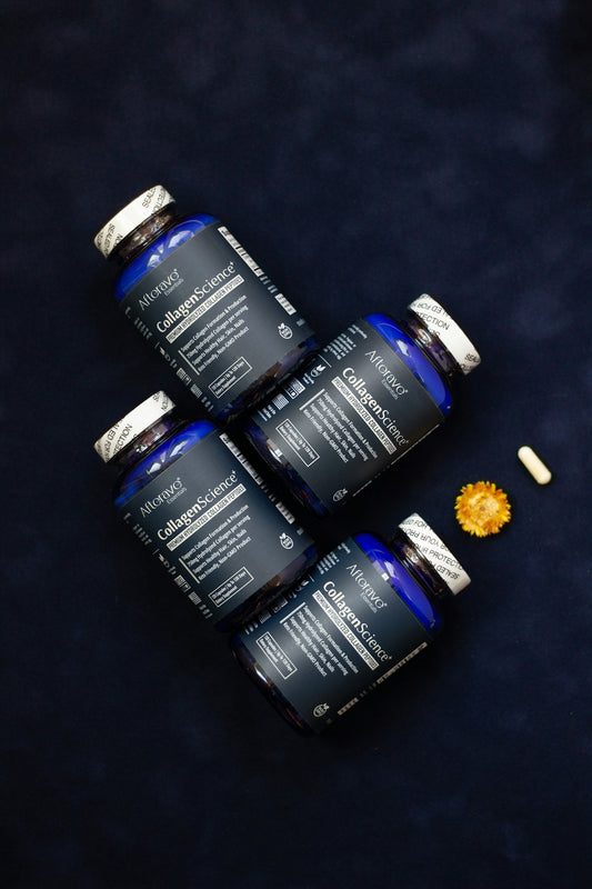 Four bottles of vitamins sitting on top of a table