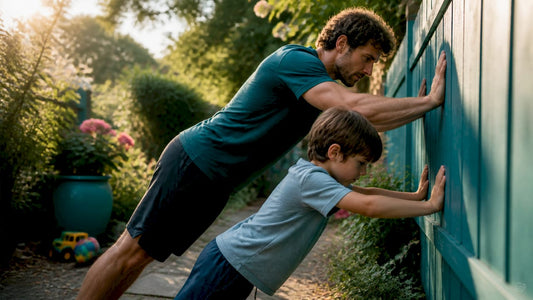 Parent and child doing wall push-ups indoors