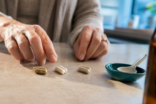 Caregiver reviewing anonymous supplement capsules