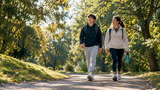 Parent and teenager walking on park path