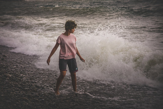 unknown person standing near body of water