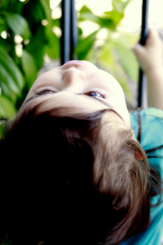 child wearing green shirt looking up