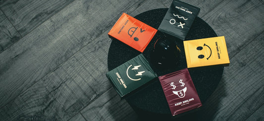 five assorted cards on black surface