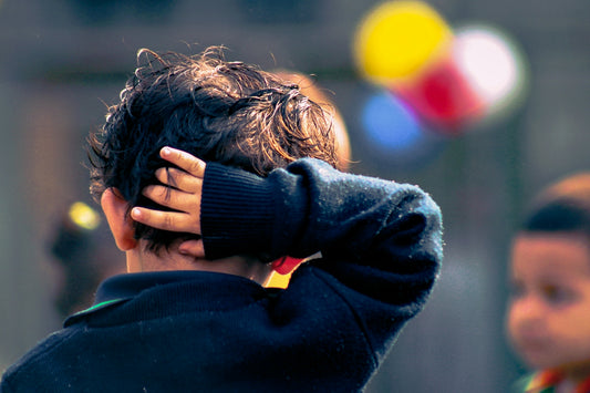 selective focus photography of boy wearing black jacket