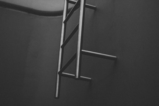 a black and white photo of a ladder