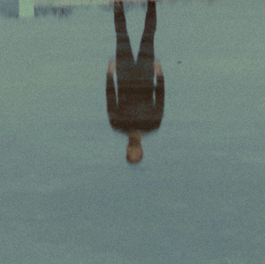 a person standing in the water with an umbrella