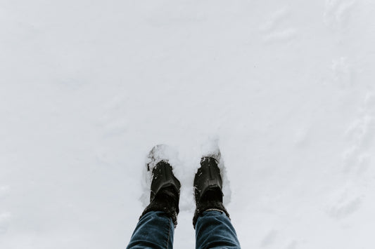 person standing on snow covered field