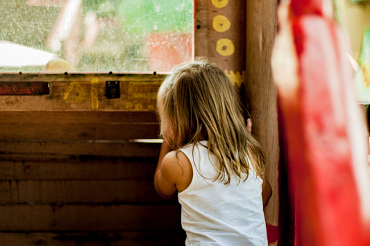 girl standing near brown wall