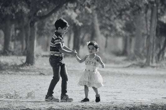 man and woman holding hands while walking on the road