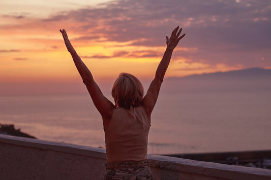 woman in white shirt raising her hands
