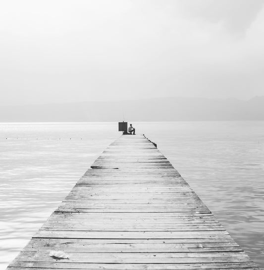grayscale photo of wooden dock on sea