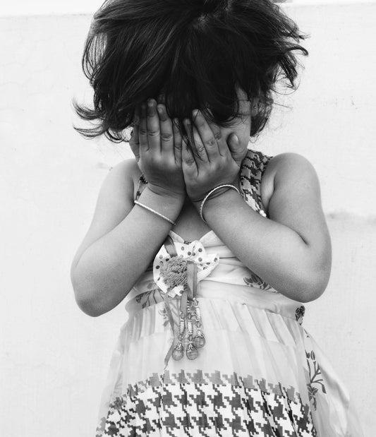 girl in white dress covering face with hair