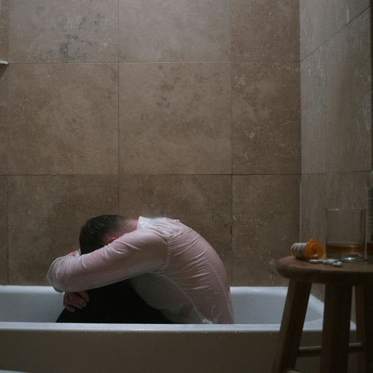 woman in pink long sleeve shirt on bathtub