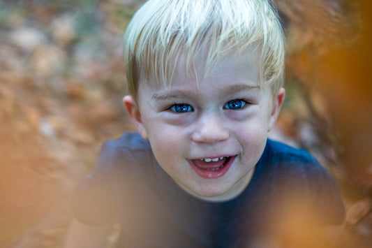 smiling boy in blue crew neck shirt