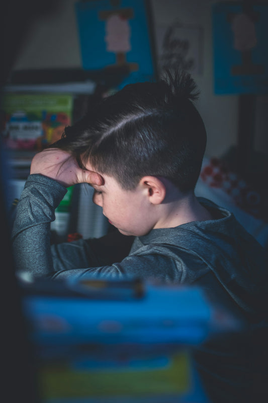 boy in black hoodie sitting on chair