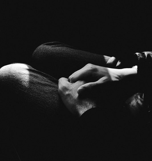 grayscale photo of persons feet on sofa