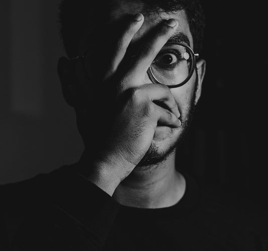 man in black crew neck shirt wearing black framed eyeglasses