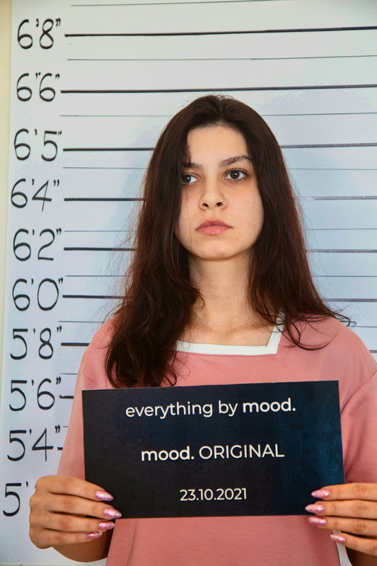 a woman holding a sign that says everything by mood