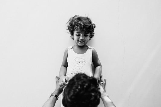 a man holding a little girl in his arms