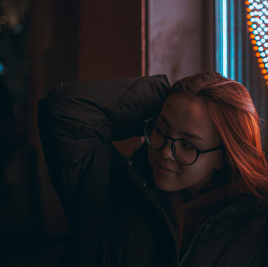 a woman with red hair wearing glasses