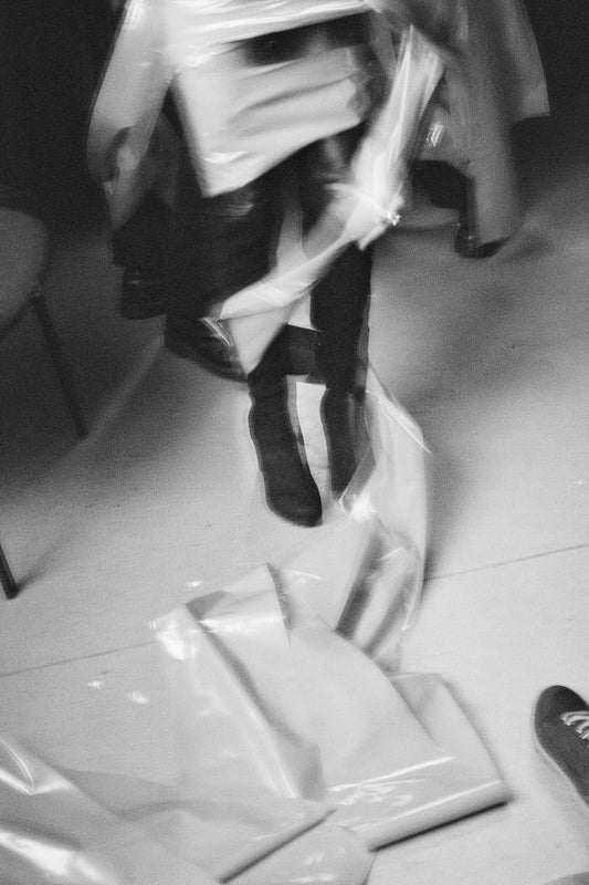 a black and white photo of a person holding a bag