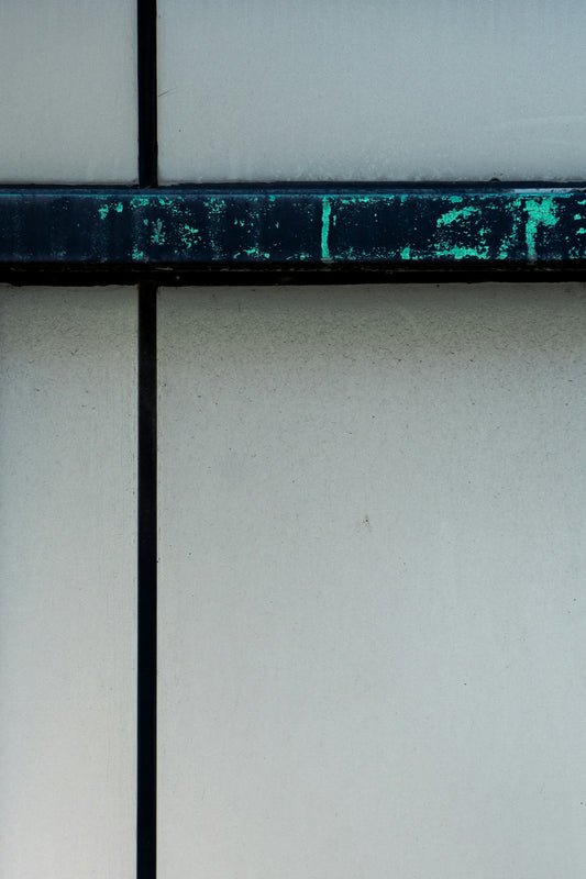 a close up of a blue and green sign on a wall