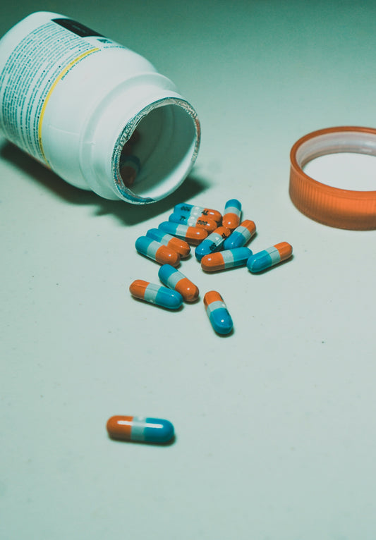 a bottle of pills sitting next to some pills