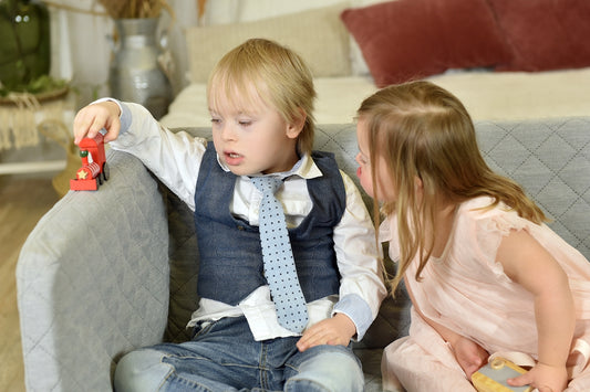 a little boy and a little girl sitting on a couch