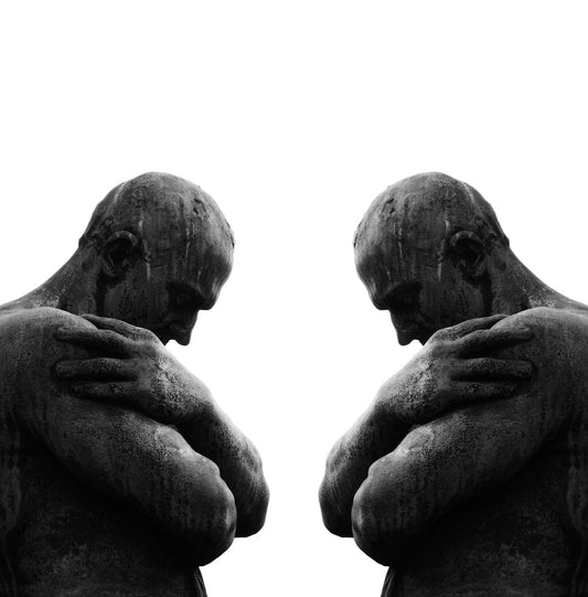 a statue of a man holding his hands to his chest
