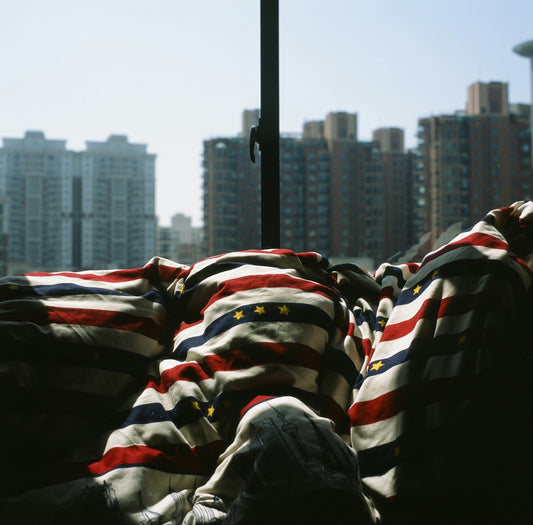 a person lying on a bed with a city skyline in the background