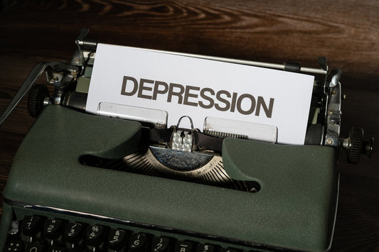 a close up of a typewriter with a paper that reads depression