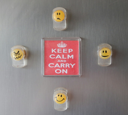 a refrigerator with magnets and smiley faces on it