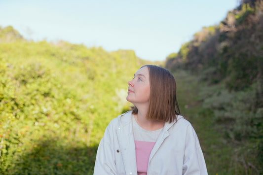 a person standing in front of a bush