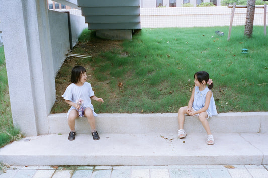 two children sitting on steps