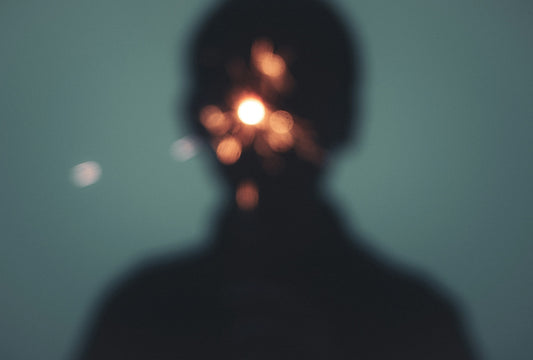 a person's head with a light shining on it