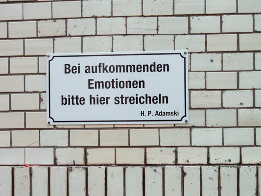 a sign on a brick wall