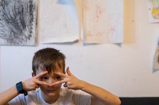 a boy with his hands on his face