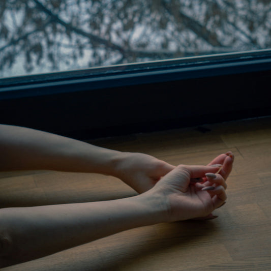 a person sitting on the floor with their legs crossed