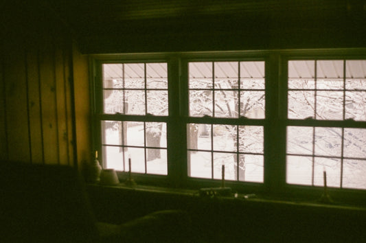 a dark room with a window and a sink