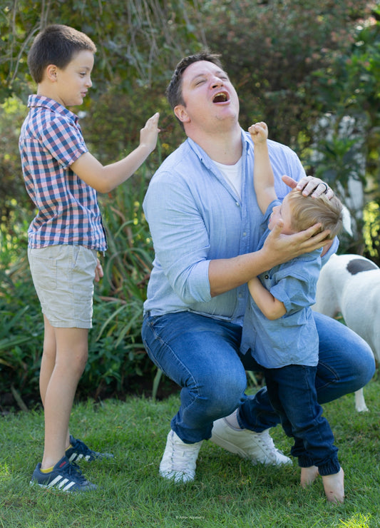 a man holding a young boy in his arms