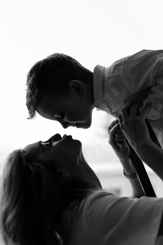 a woman holding a baby up to her face