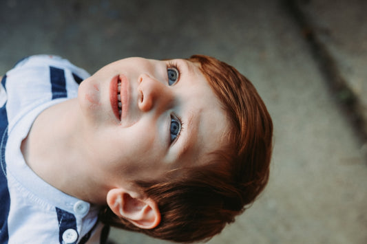 a young boy looking up at the sky