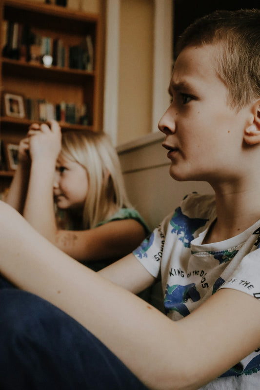 a boy and a girl sitting on a couch