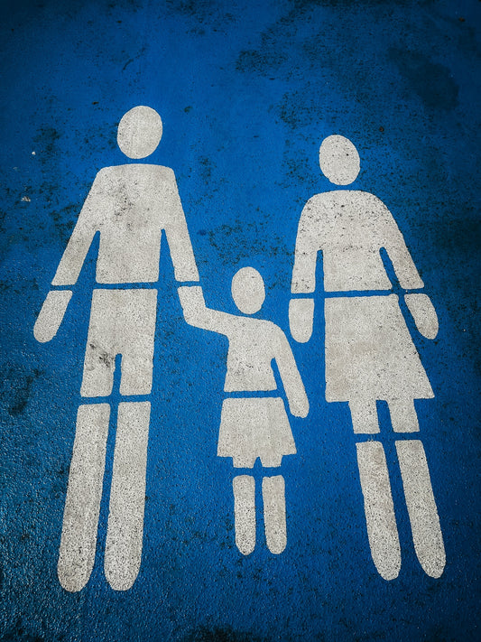 a blue and white sign with a picture of a man and a woman holding hands