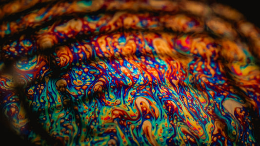 a close up of a colorful object with a black background