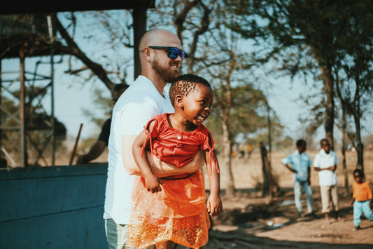 a man holding a small child in his arms