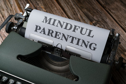 a close up of a typewriter with a paper that says mindful parenting